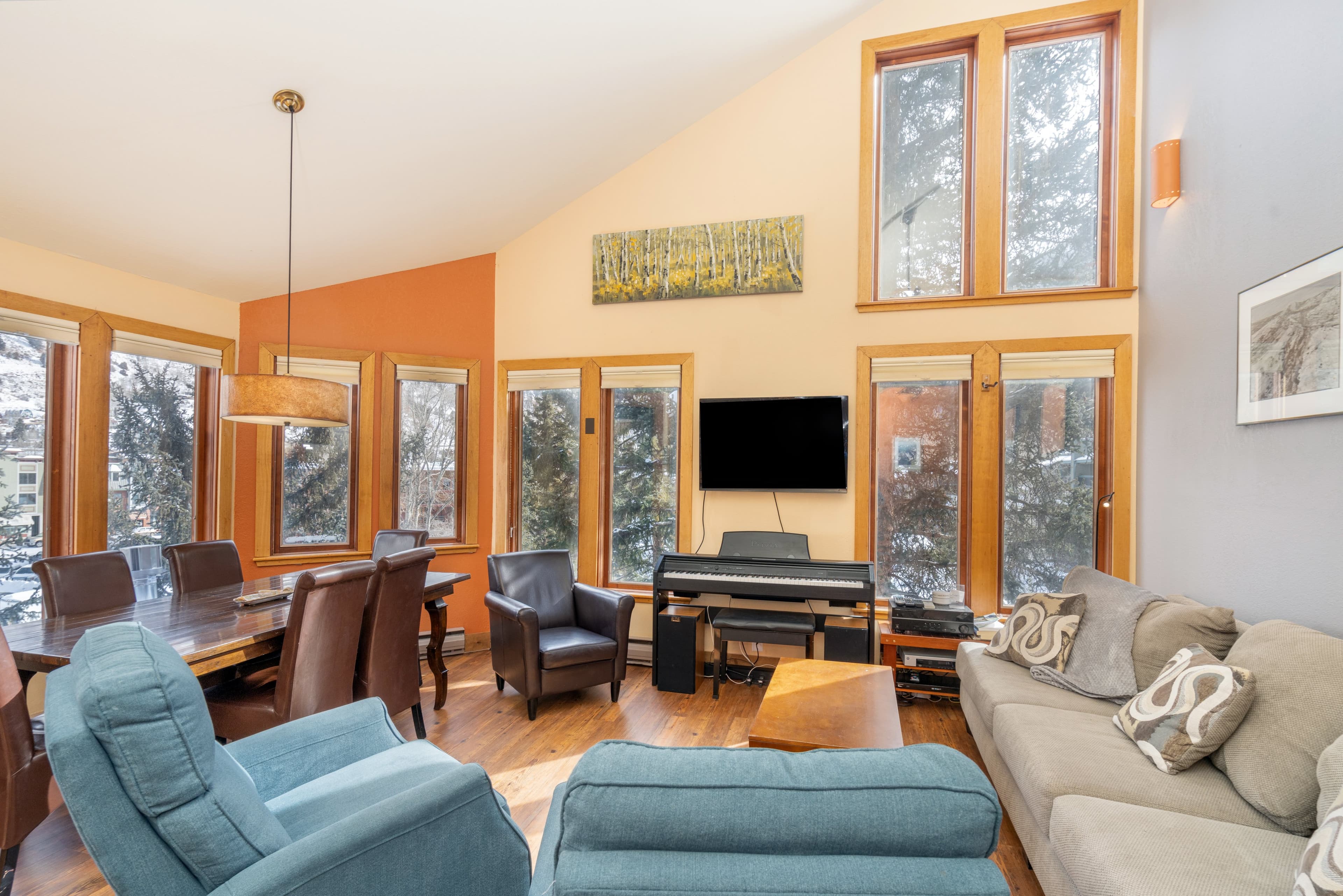 Living room with a sofa, two cozy chairs, a tv