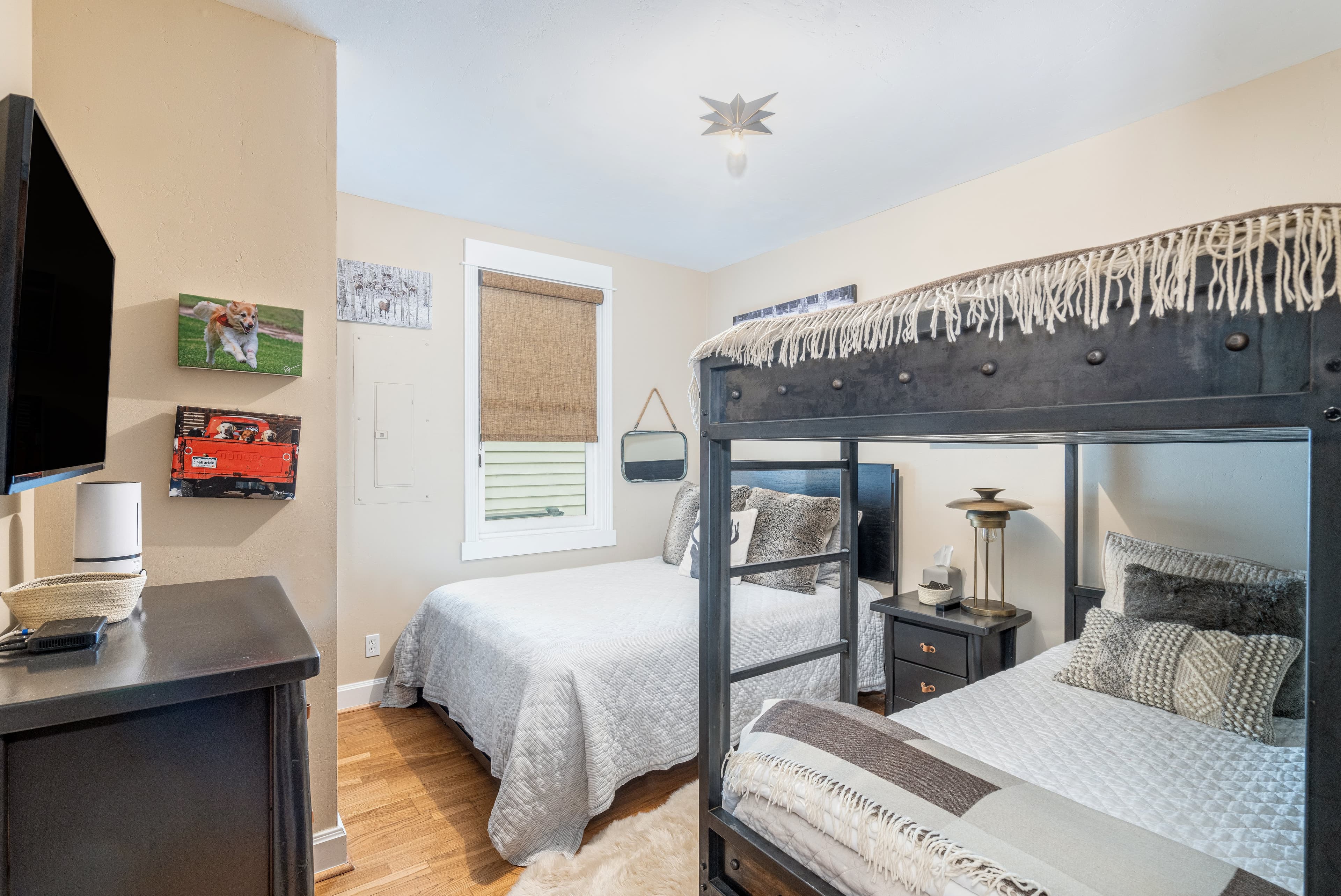 First floor bunk room with a set of twin bunks and a queen bed.